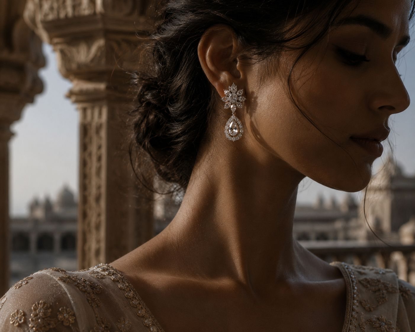 A woman in profile at a palace balustrade wearing a diamond floral drop earring